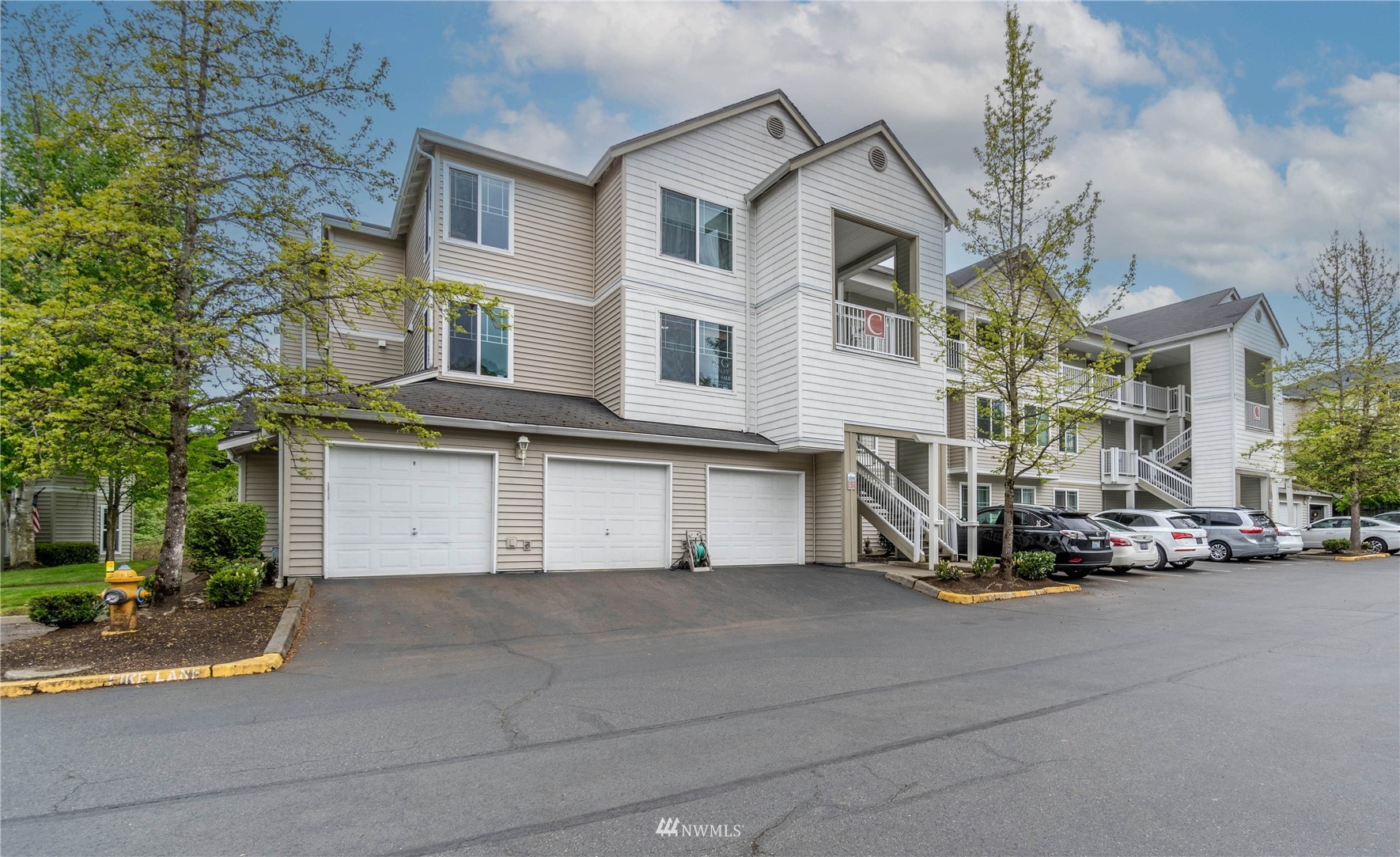 2009 196th Street Southeast, Unit C201 Bothell, WA 98012 - Photo 1 of 36 a front view of a house with a yard and garage