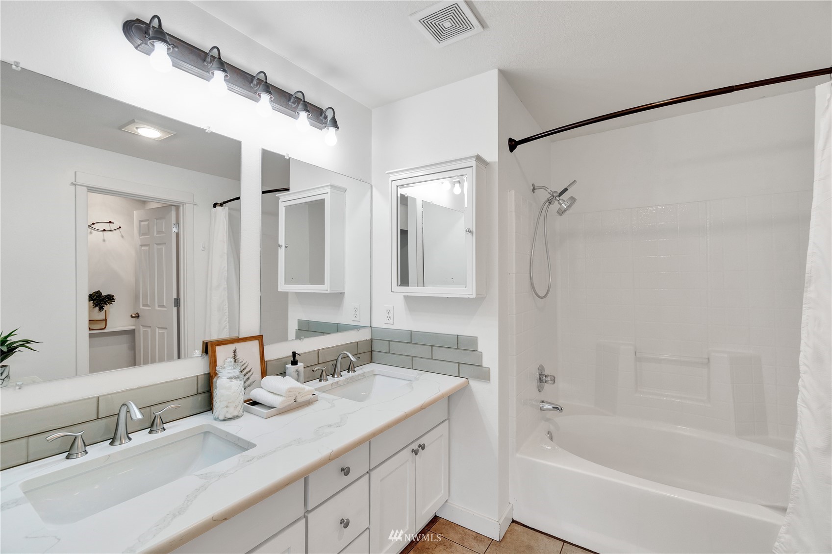 2009 196th Street Southeast, Unit C201 Bothell, WA 98012 - Photo 24 of 36 a bathroom with a granite countertop sink mirror and a bathtub