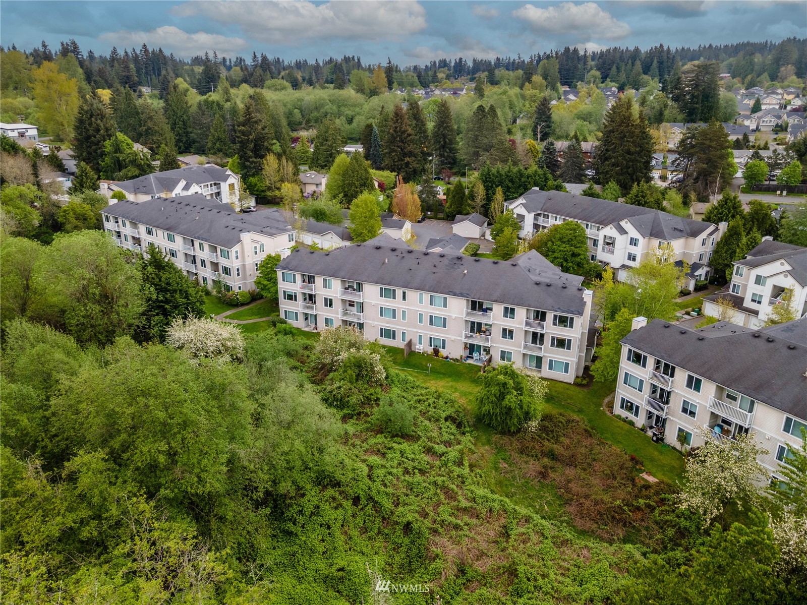2009 196th Street Southeast, Unit C201 Bothell, WA 98012 - Photo 33 of 36 an aerial view of multiple houses with a yard
