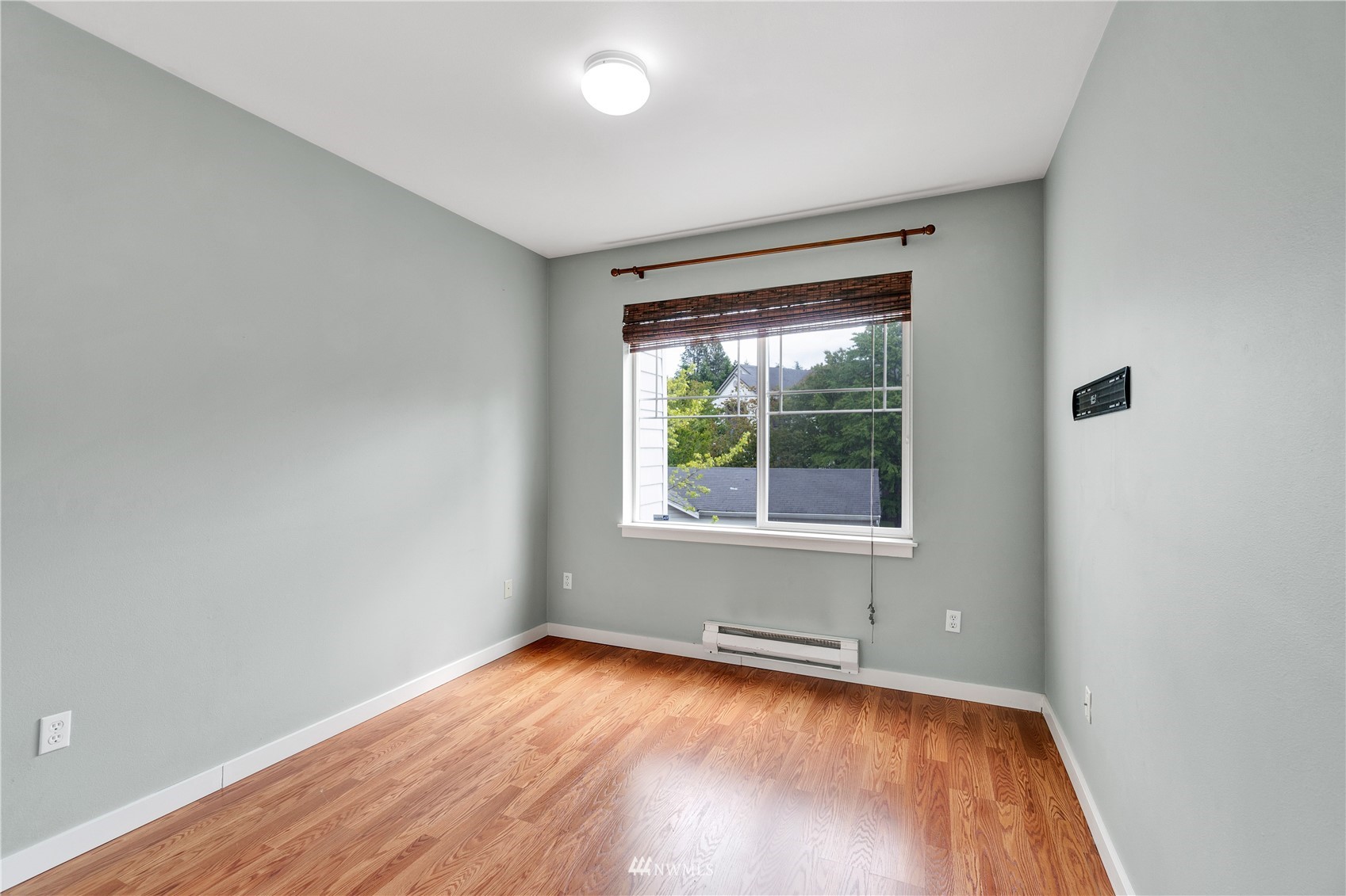 2009 196th Street Southeast, Unit C201 Bothell, WA 98012 - Photo 7 of 36 an empty room with wooden floor and windows