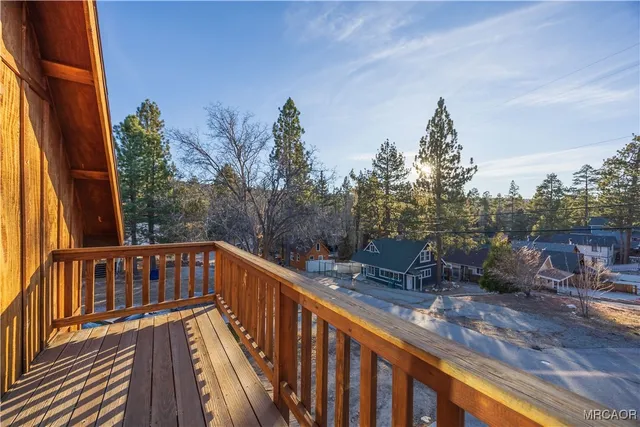a view of a balcony with wooden fence and floor