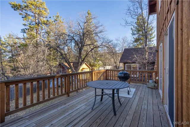 a view of a wooden chairs and table on the deck