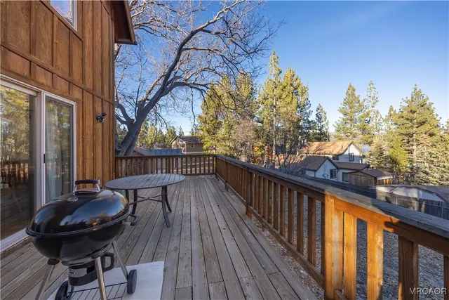 a view of balcony with wooden floor and outdoor seating