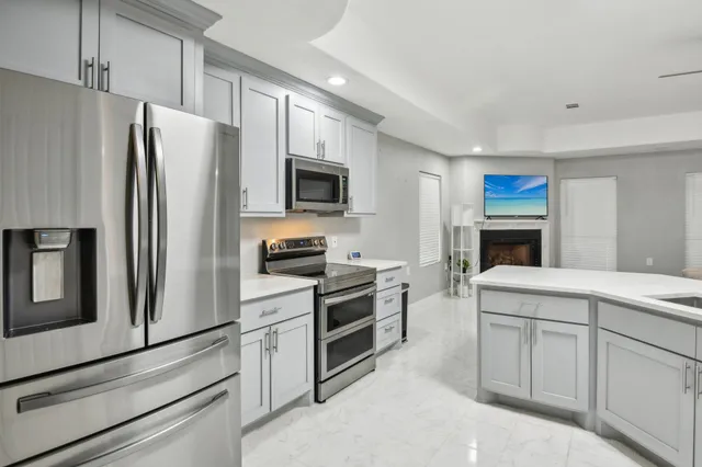 a large kitchen with a table and chairs