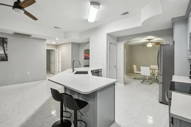 a kitchen with cabinets a sink dishwasher a stove and a refrigerator with wooden floor