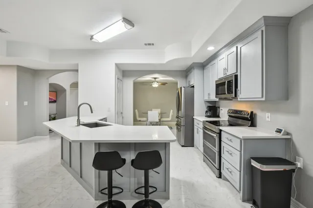 a kitchen with cabinets a sink and appliances
