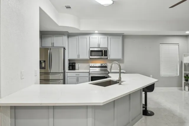 a view of a room with a ceiling fan and a window
