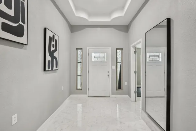 a living room with furniture and large windows