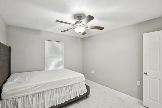a bathroom with a sink a toilet and shower curtain