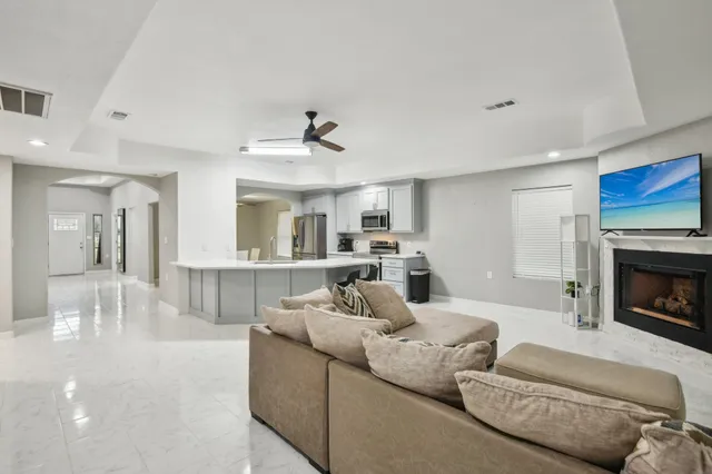 a kitchen with a refrigerator a microwave a dining table and chairs