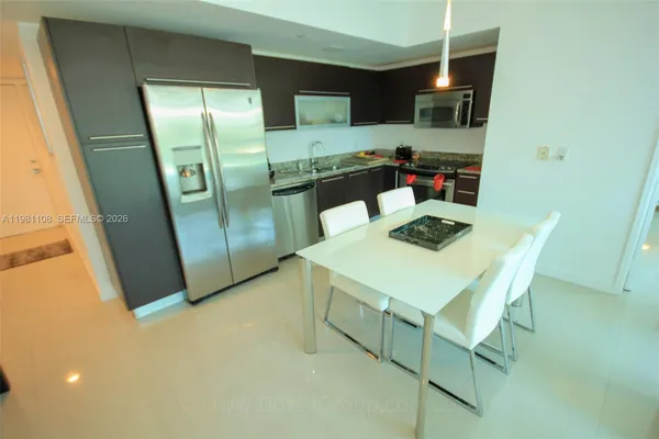 a kitchen with a refrigerator and a sink