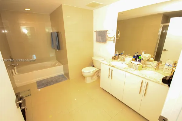 a bathroom with a sink a toilet and a shower