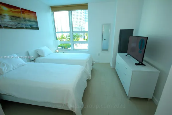 a bed sitting in a bedroom next to a window