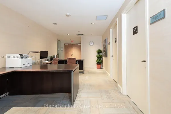 a view of a workspace with furniture and a potted plant