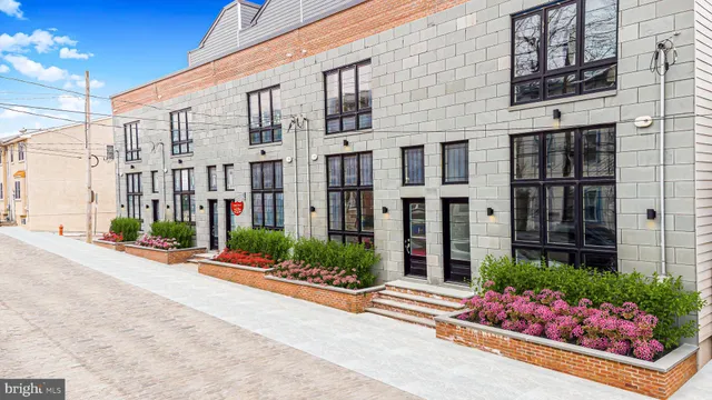a front view of a building with potted plants