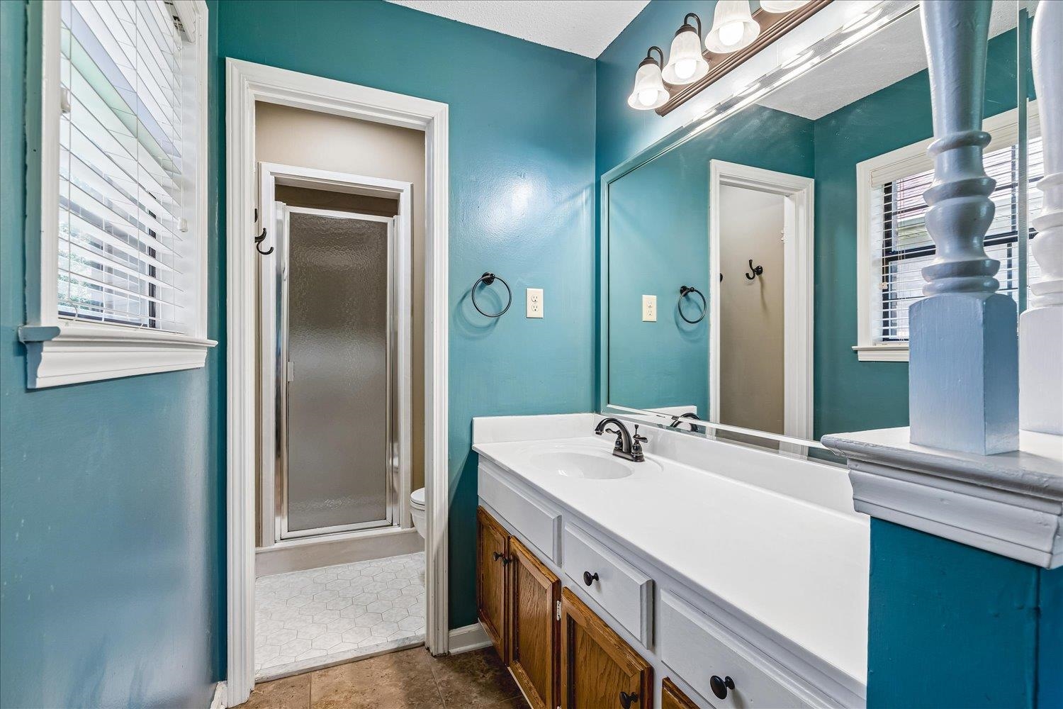 5711 Yale Road Bartlett, TN 38134 - Photo 15 of 29 Bathroom featuring a vanity with wood-finish cabinetry, a single basin sink, and a large wall-mounted mirror