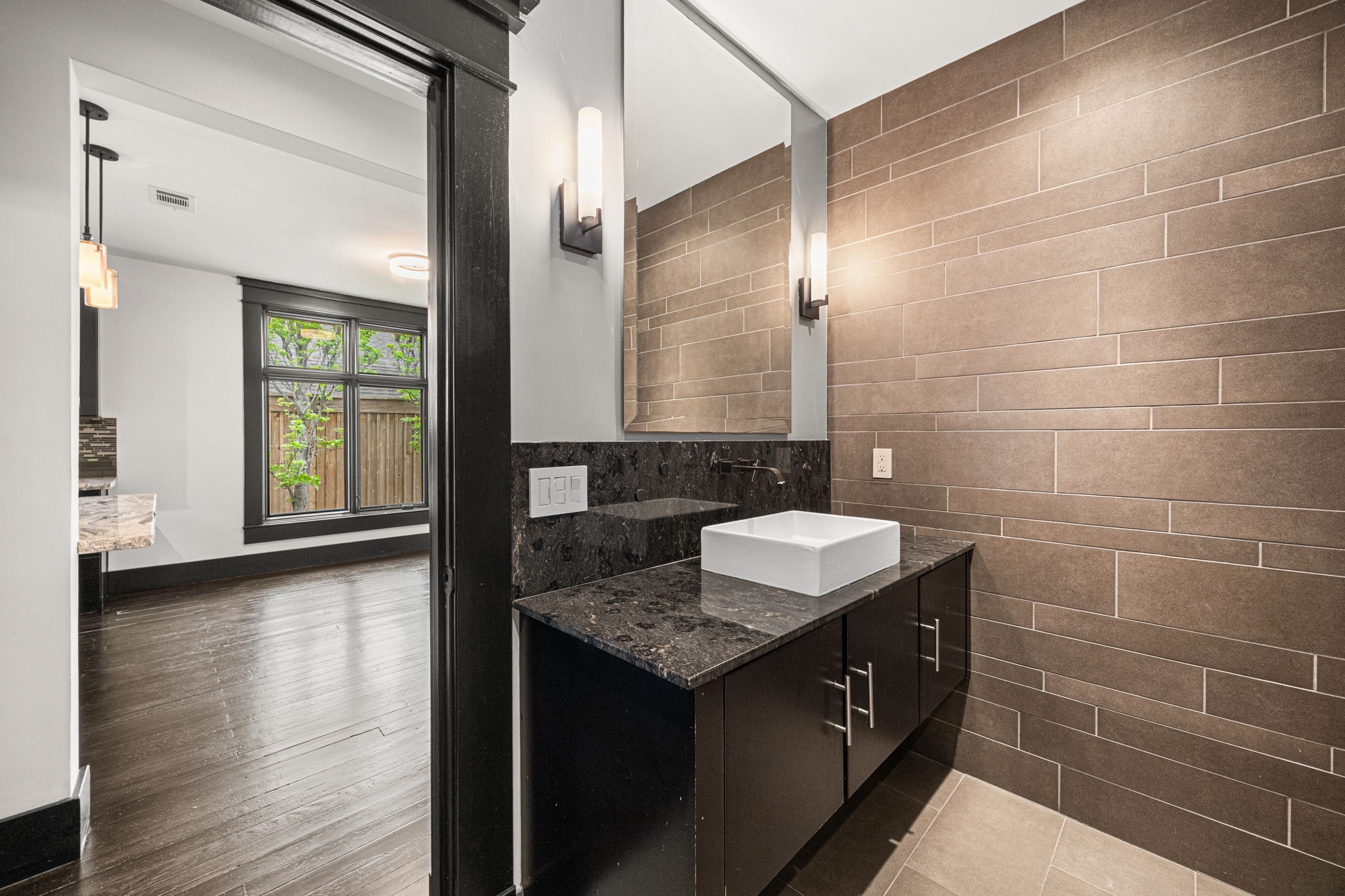 1115 Adele Street Houston, TX 77009 - Photo 13 of 19 Stylish powder bath with modern vanity, vessel sink, and upgraded lighting.