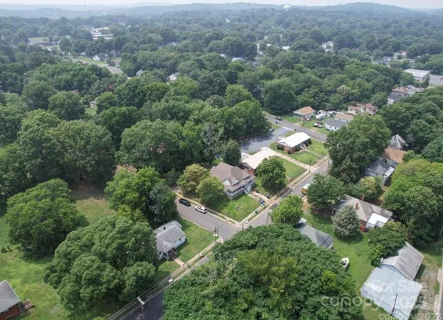 an aerial view of a houses with yard and outdoor seating