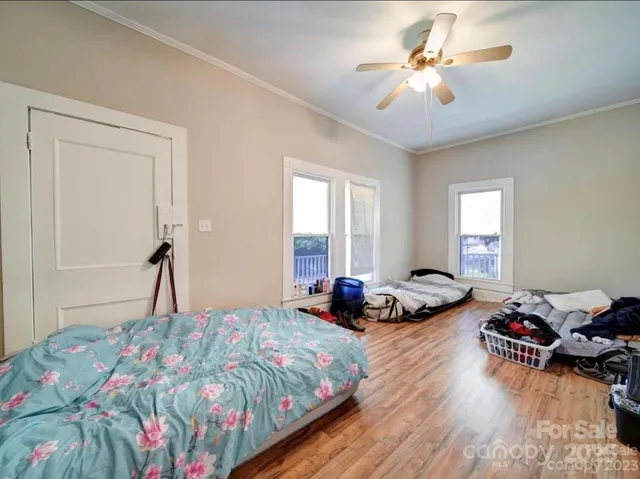 a bedroom with bed and a chandelier