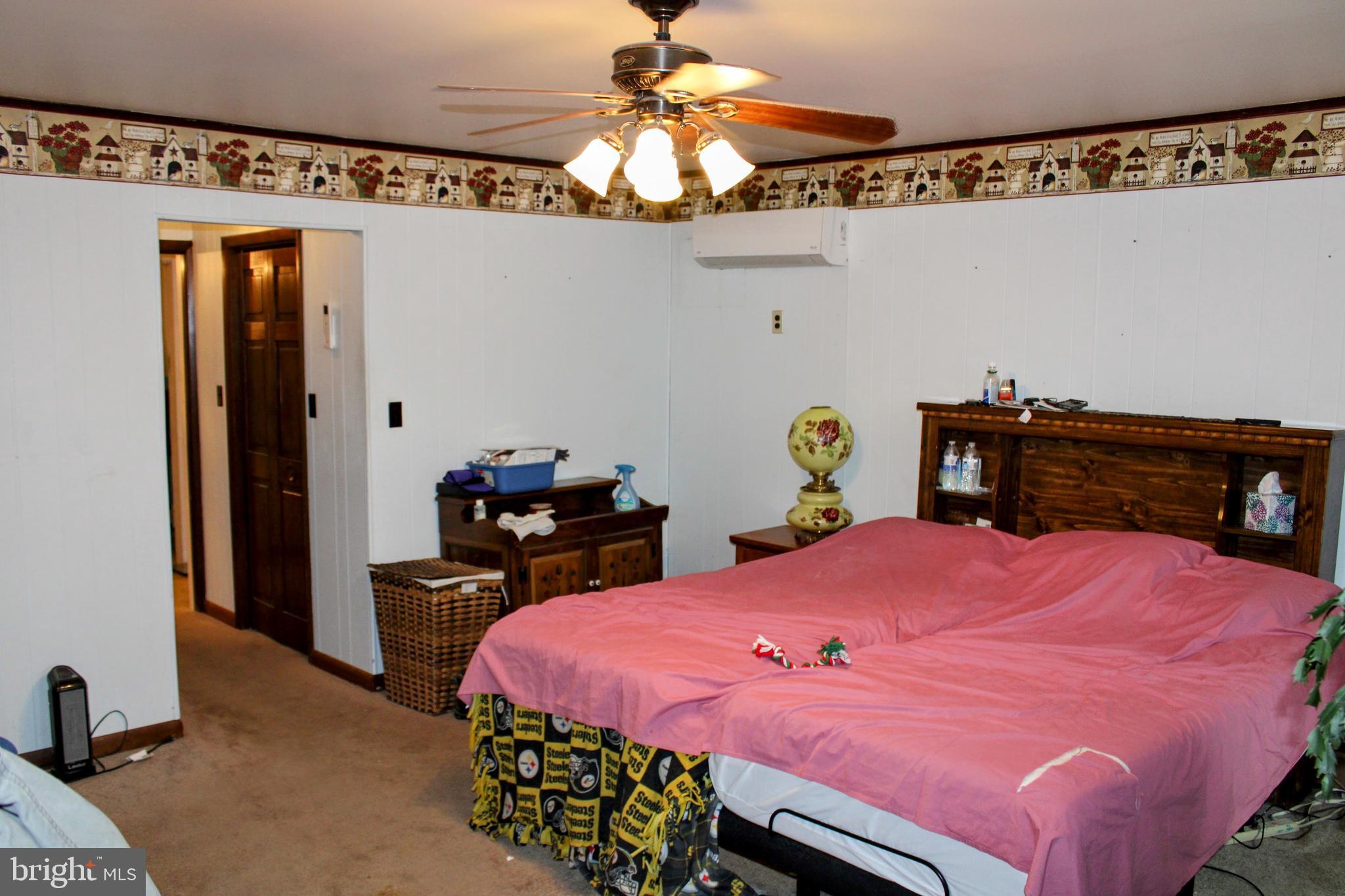 1928 New Bloomfield Road New Bloomfield, PA 17068 - Photo 5 of 15 a bed room with a bed and a chandelier