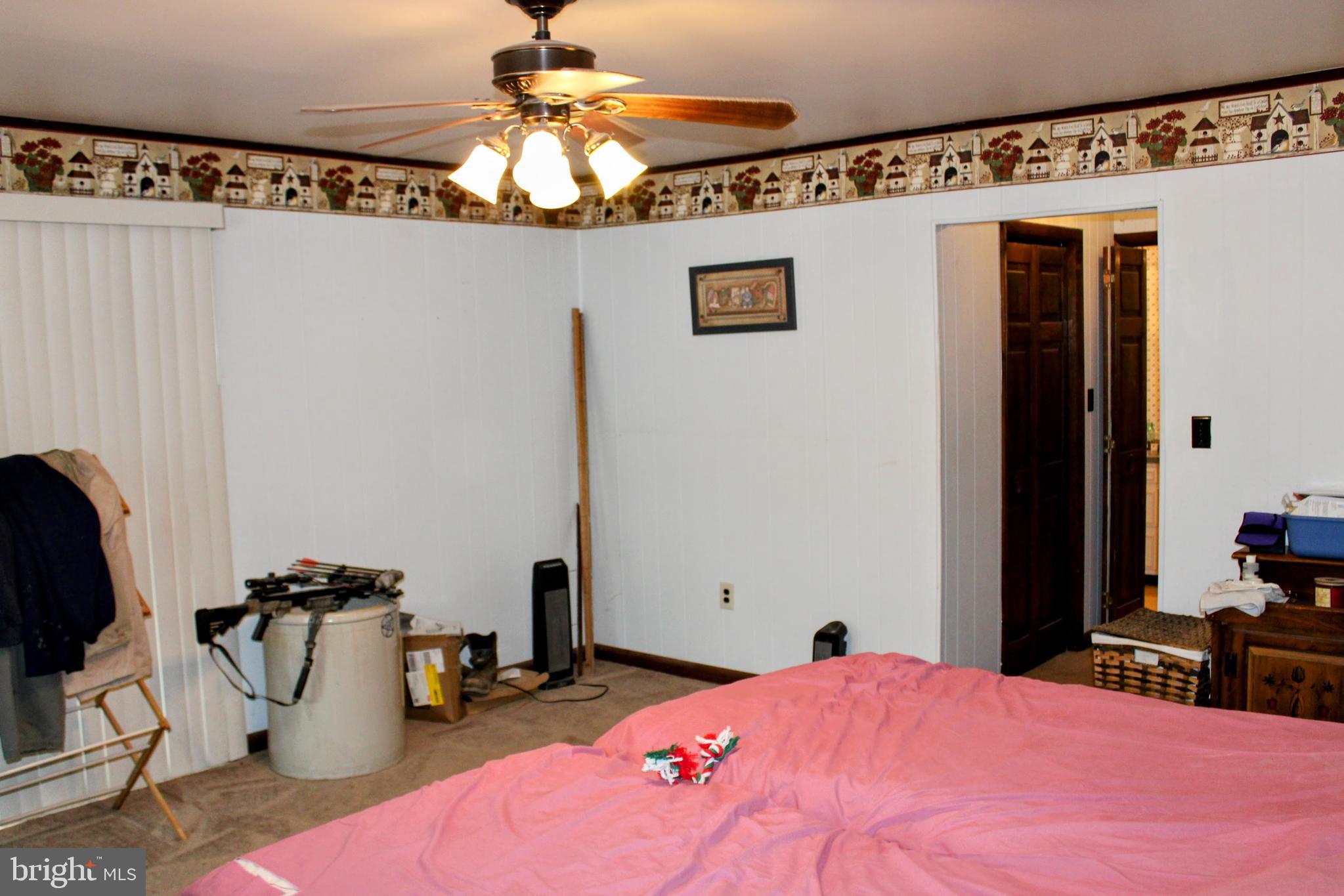 1928 New Bloomfield Road New Bloomfield, PA 17068 - Photo 6 of 15 a bedroom with a bed and a chandelier