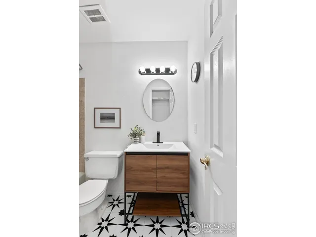 an empty room with wooden floor and ceiling fan