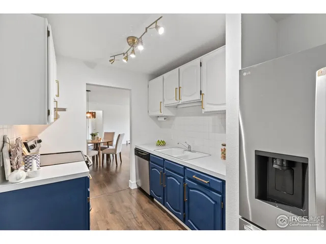 a kitchen with kitchen island granite countertop a sink cabinets and stainless steel appliances