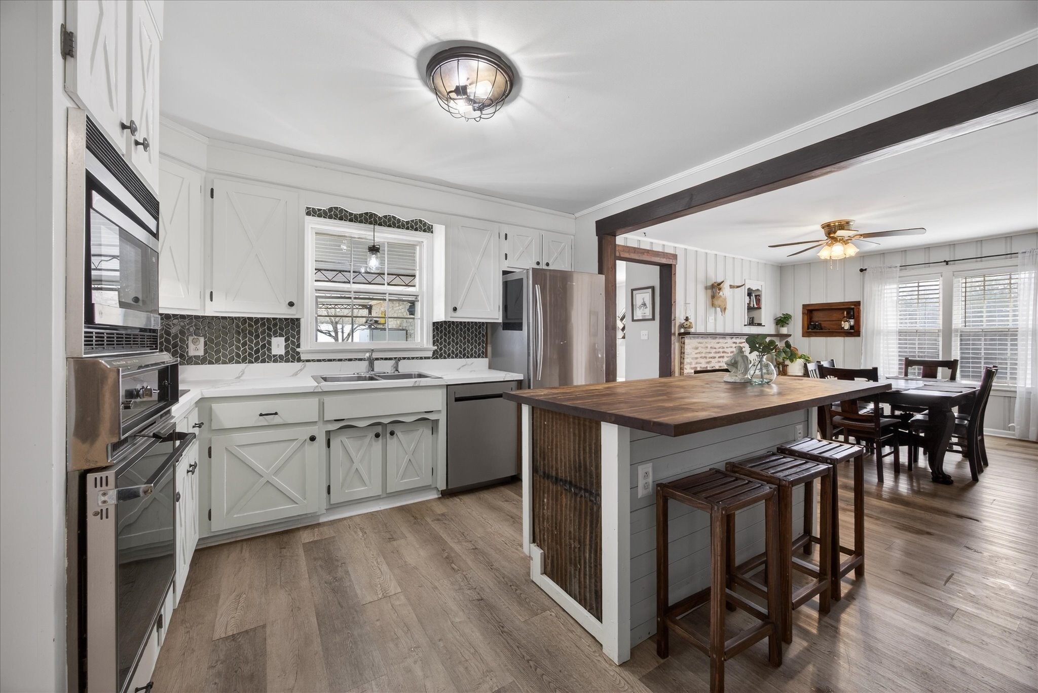 3212 Marthas Chapel Road Cunningham, TN 37052 - Photo 1 of 32 a kitchen with stove a sink dishwasher a dining table and chairs with wooden floor