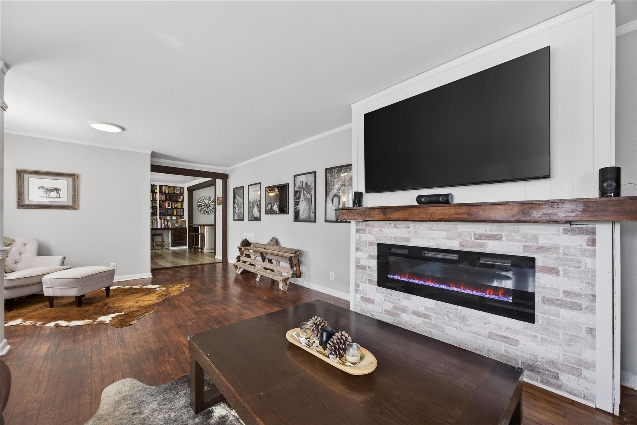 3212 Marthas Chapel Road Cunningham, TN 37052 - Photo 2 of 32 a living room with furniture a flat screen tv and a fireplace