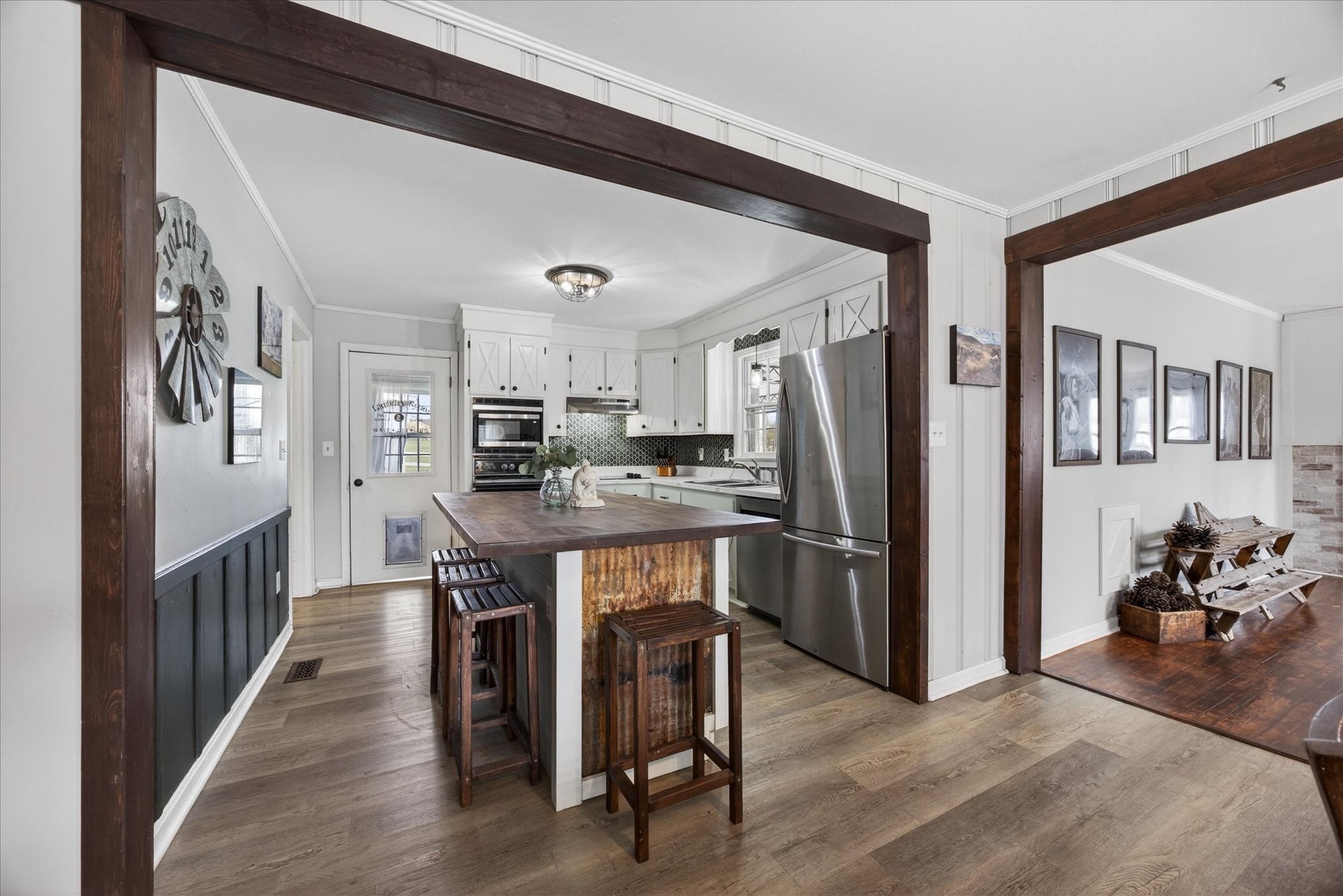 3212 Marthas Chapel Road Cunningham, TN 37052 - Photo 6 of 32 a kitchen with stainless steel appliances granite countertop a refrigerator a stove a sink dishwasher and a dining table with wooden floor