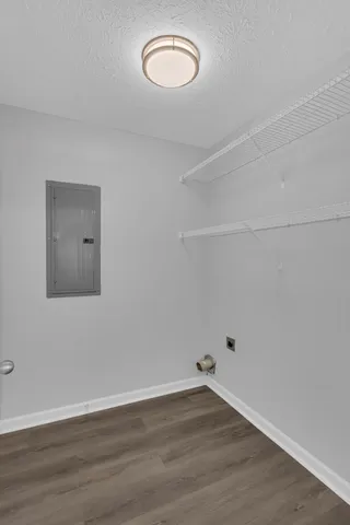 a view of a room with wooden floor and fan