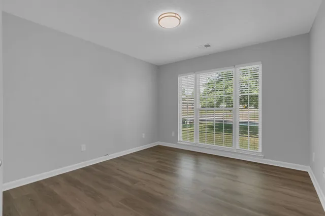 a view of wooden floor and windows in a room
