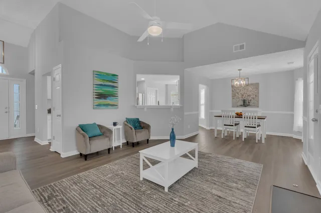 a living room with furniture and wooden floor