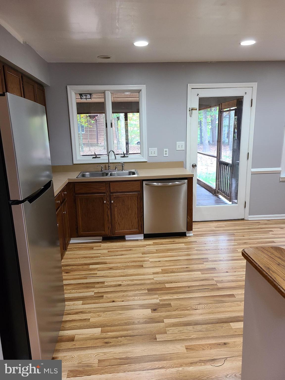 a large kitchen with granite countertop a sink and a stove top oven