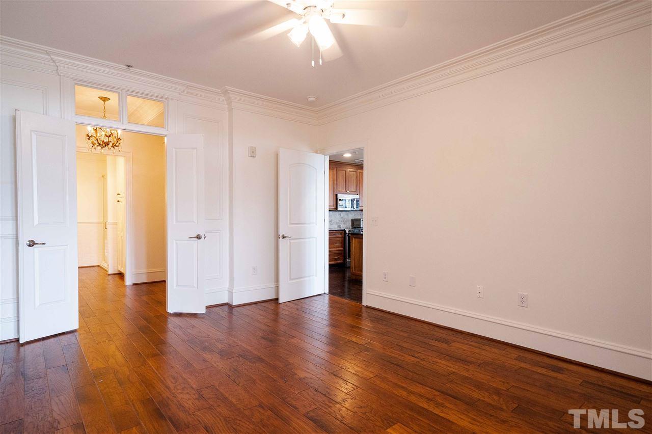 710 Independence Place, Unit 407 Raleigh, NC 27603 - Photo 16 of 27 an empty room with wooden floor and a window