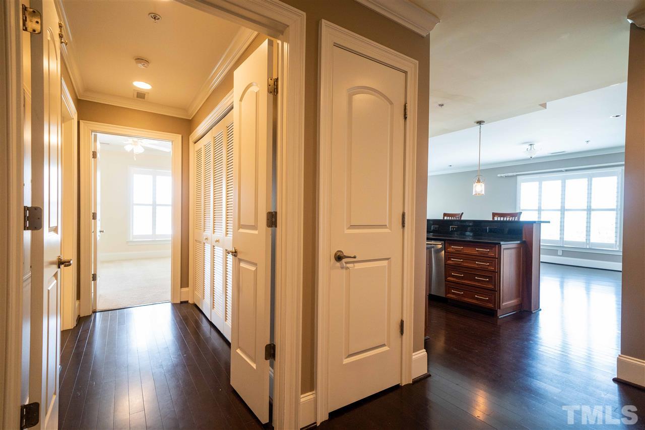 710 Independence Place, Unit 407 Raleigh, NC 27603 - Photo 17 of 27 a view of a hallway with wooden floor and furniture
