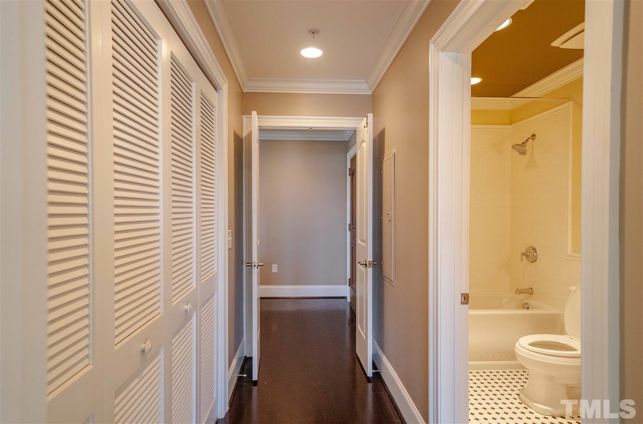 710 Independence Place, Unit 407 Raleigh, NC 27603 - Photo 21 of 27 a bathroom with a granite countertop sink toilet and shower