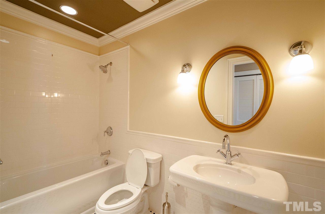 710 Independence Place, Unit 407 Raleigh, NC 27603 - Photo 22 of 27 a bathroom with a sink a toilet and a mirror