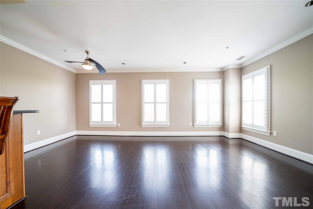 710 Independence Place, Unit 407 Raleigh, NC 27603 - Photo 6 of 27 a view of an empty room with wooden floor and a window