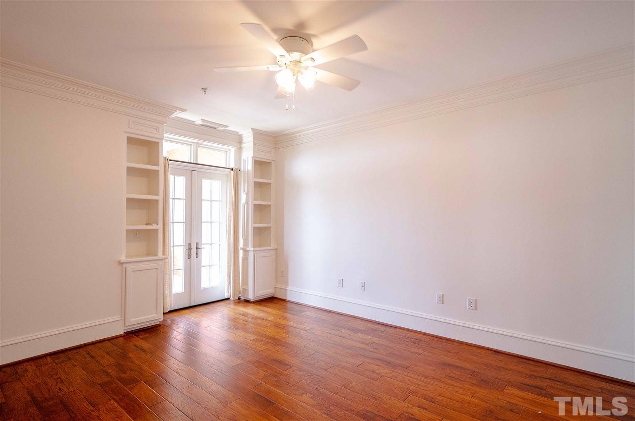 710 Independence Place, Unit 407 Raleigh, NC 27603 - Photo 9 of 27 an empty room with wooden floor and window