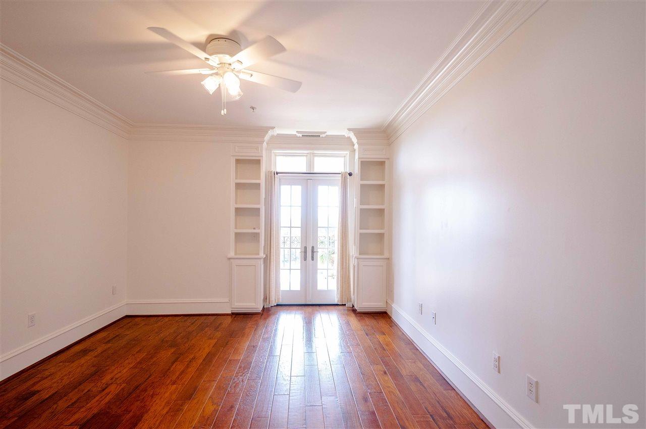 710 Independence Place, Unit 407 Raleigh, NC 27603 - Photo 10 of 27 wooden floor in an empty room with a window