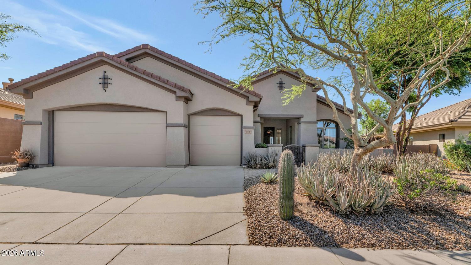 41123 North River Bend Road Phoenix, AZ 85086 - Photo 28 of 45 a front view of a house with garden