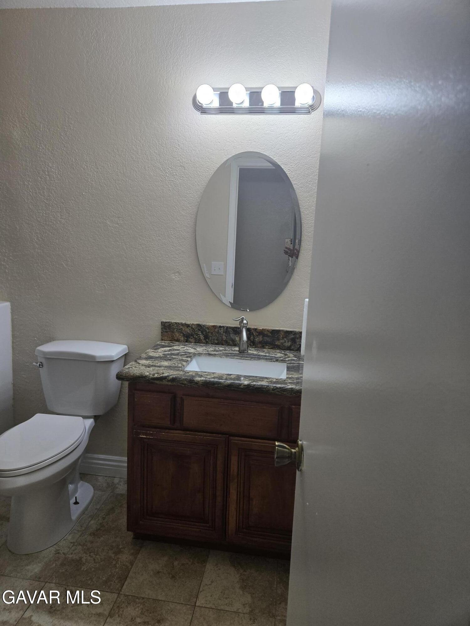 2128 Edam Street Lancaster, CA 93536 - Photo 14 of 26 a bathroom with a toilet and a sink