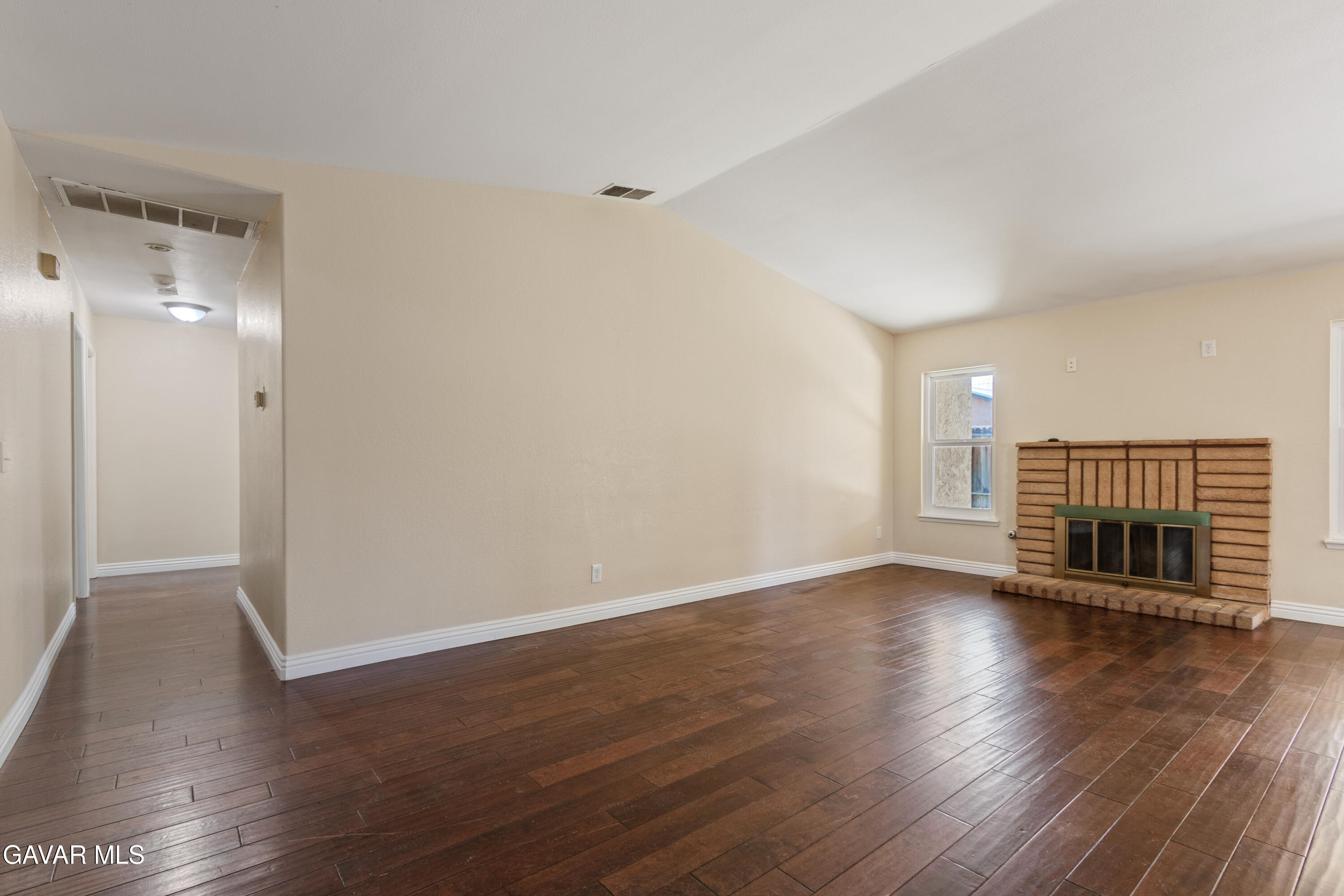 2128 Edam Street Lancaster, CA 93536 - Photo 15 of 26 an empty room with wooden floor and fireplace