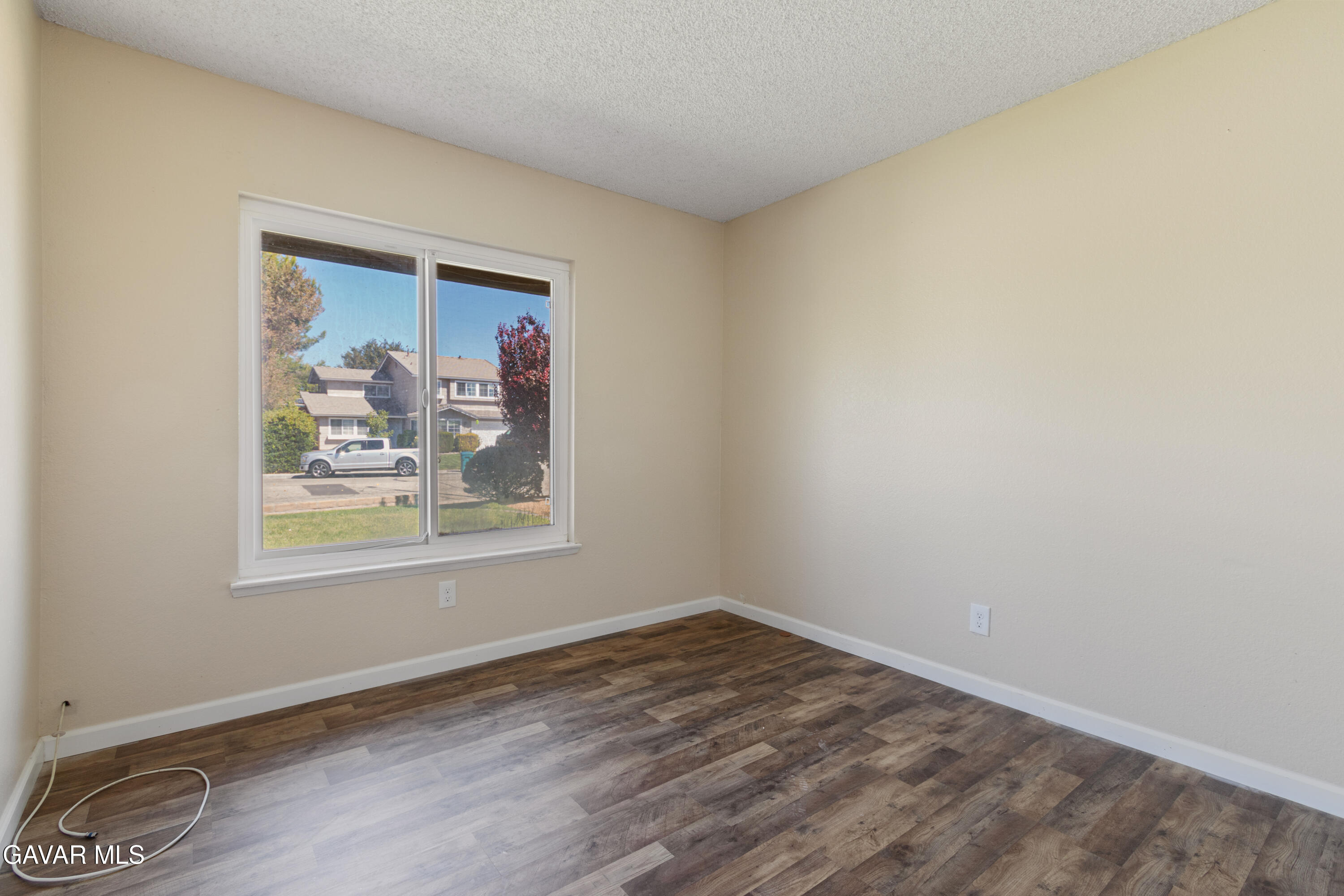 2128 Edam Street Lancaster, CA 93536 - Photo 17 of 26 an empty room with wooden floor and a window