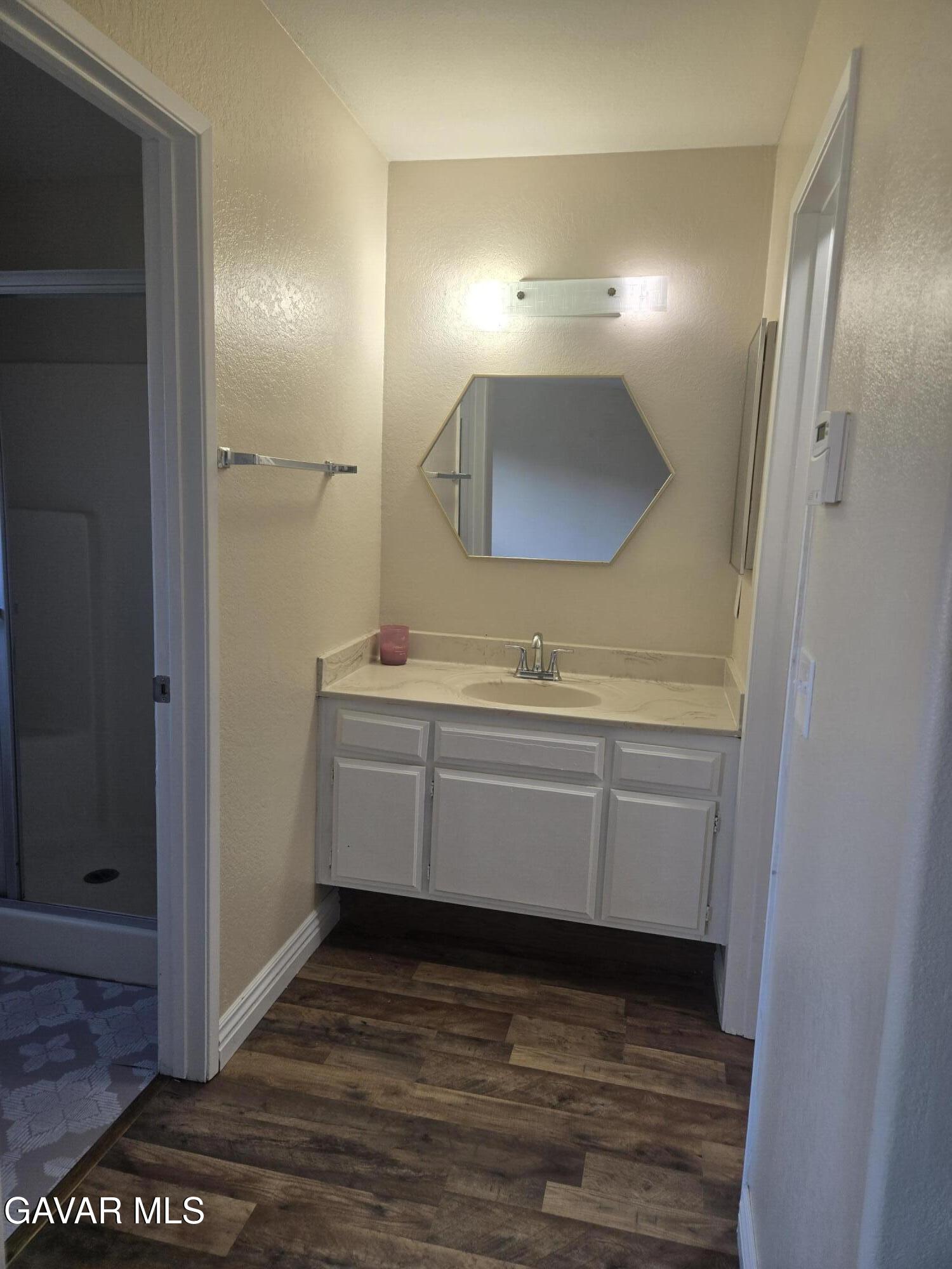 2128 Edam Street Lancaster, CA 93536 - Photo 23 of 26 a bathroom with a sink a vanity and a mirror