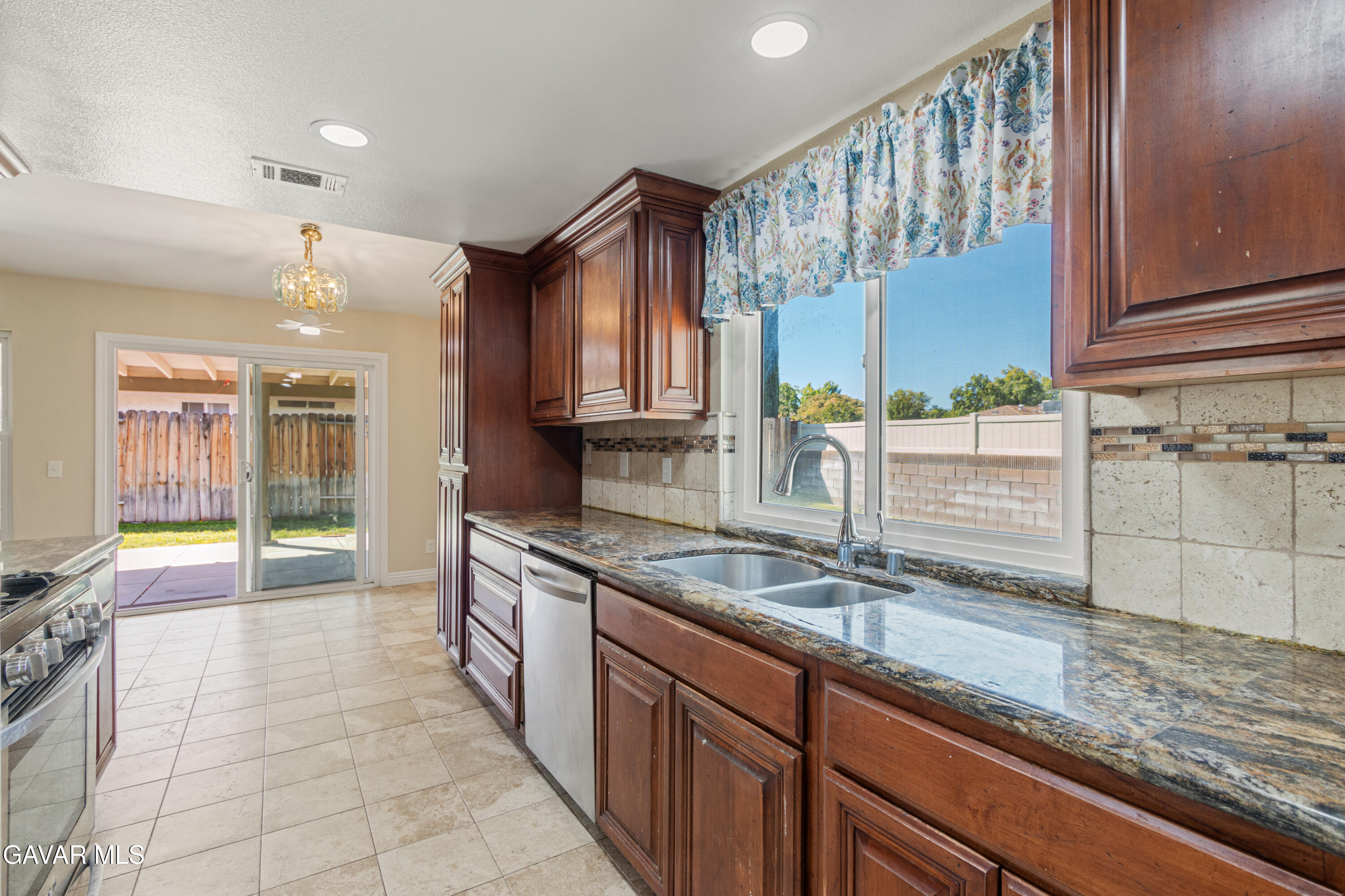 2128 Edam Street Lancaster, CA 93536 - Photo 10 of 26 a kitchen with granite countertop a sink and a stove
