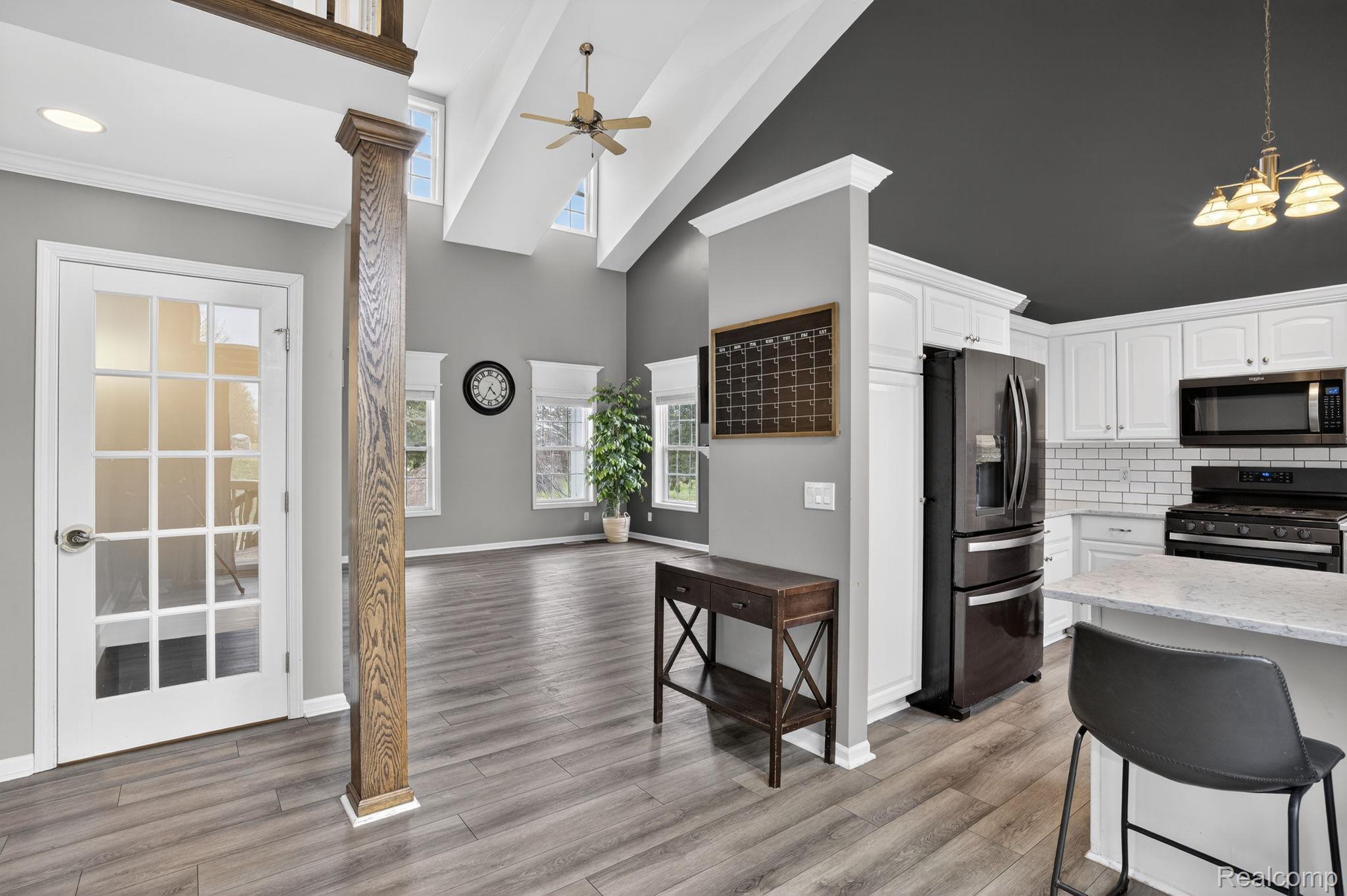 9055 Hegel Road Grand Blanc, MI 48439 - Photo 25 of 62 Vaulted ceilings with high windows complement the open-concept design featuring wood-finish flooring