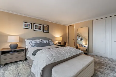 a bedroom with a bed and wooden floor
