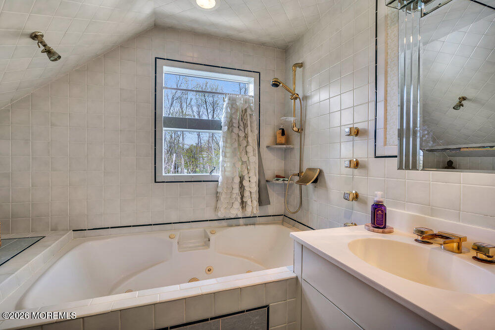 34 State Route Colts Neck, NJ 07722 - Photo 9 of 40 a bathroom with a tub sink and mirror